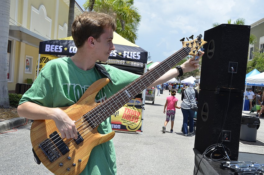 Bryant Crawford tunes his bass guitar before performing with Everyone Rocks, a rock band camp for young adults in Palmetto.