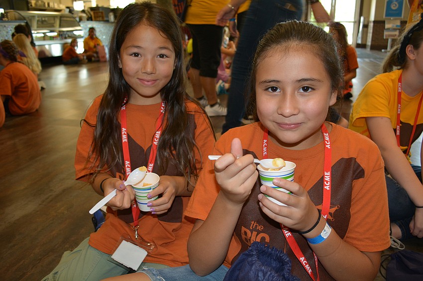 Lucy Chang and Yuliana Cervantes, both 10, eat orange dreamsicle ice cream.
