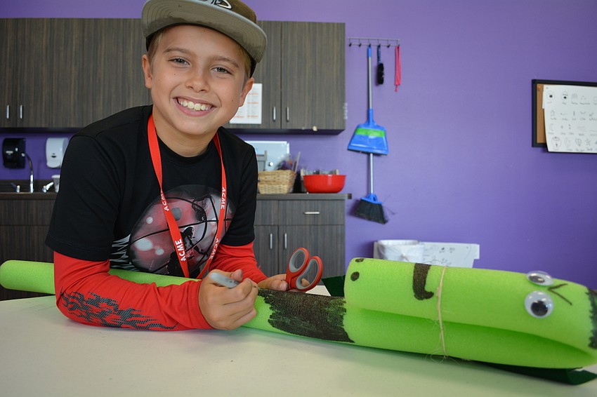 Gene Witt Elementary's Nicholas Nesser, 9, colors spots on his pool 