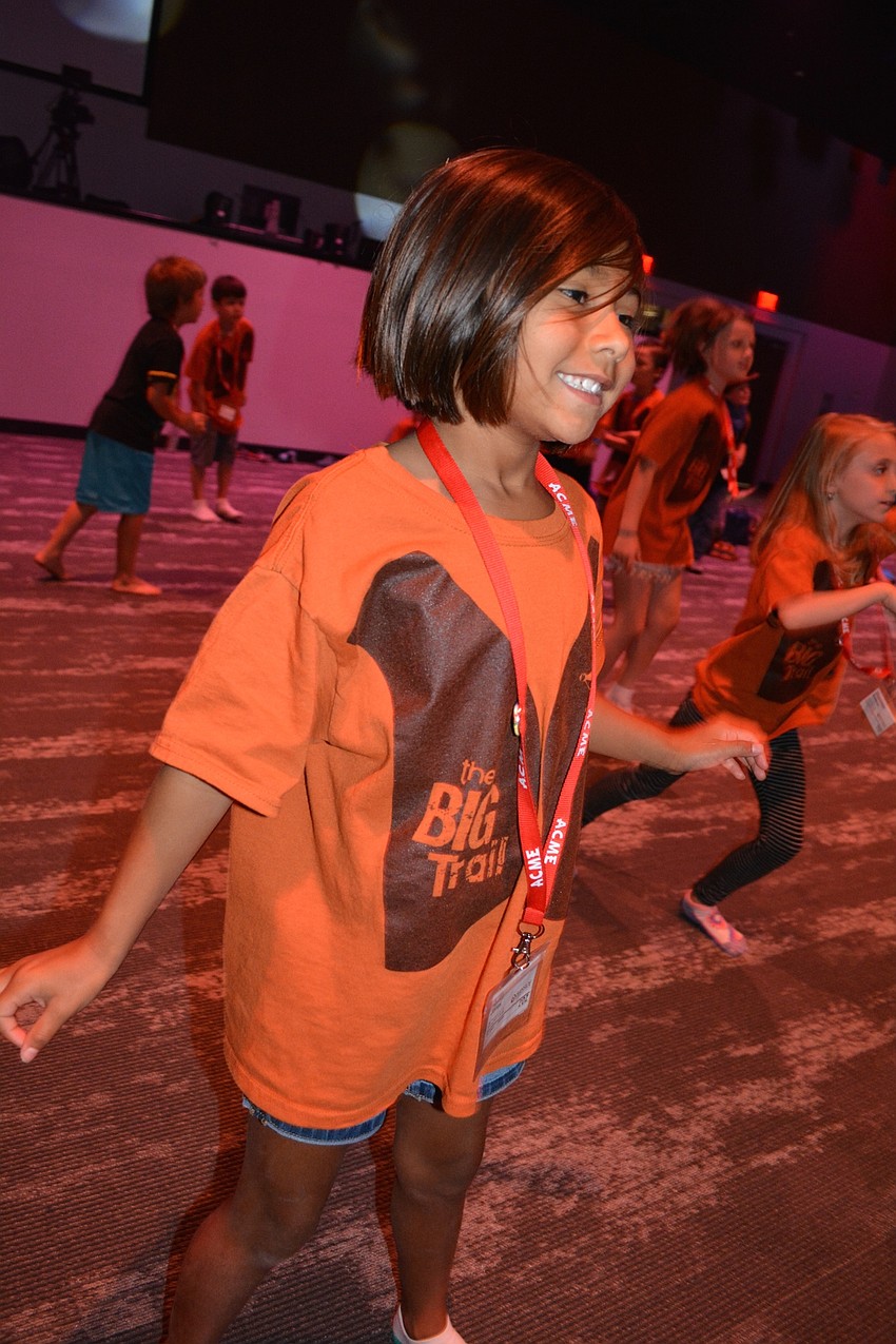 Lilly Jones, 7, dances during a time of worship.