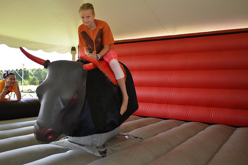 Brynna Sands rides a mechanic bull for nearly 40 seconds.