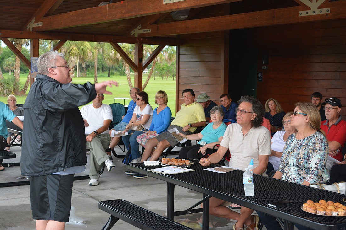 River Strand resident Tim Petz tells an interested group of local residents how they can fight the Manatee Lost Lagoon project at Tom Bennett Park.