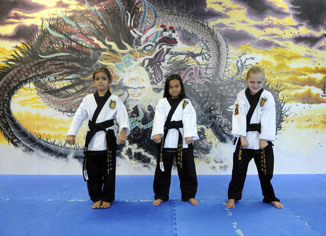 Ming Wu Martial Arts students Shanthi Marmash, 7,  Bella Valentin, 6, and Kiki Bullas, 6, all earned their first-degree black belts last month.