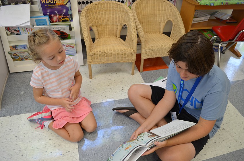 Sofia Driscoll listens closely to Sawyer Pollard as she reads 