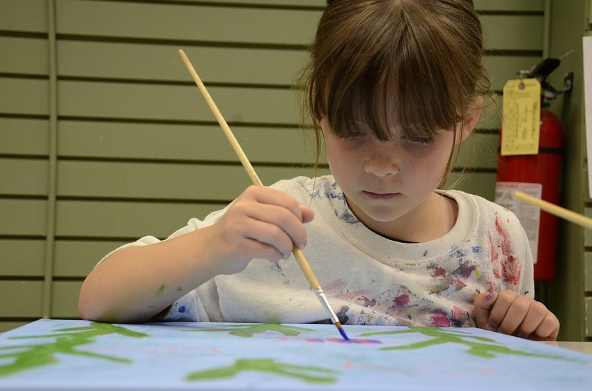 Cate Kitcher of Bradenton works on a purple fish.