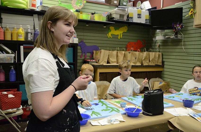 Nikki Williams tells the students to put two coats on the fish to make the color brighter and less transparent.