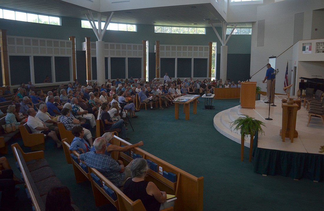 Todd Mathes presented updated renderings of Benderson Development's Siesta Promenade at a workshop at Pine Shores Presbyterian Church on Thursday.