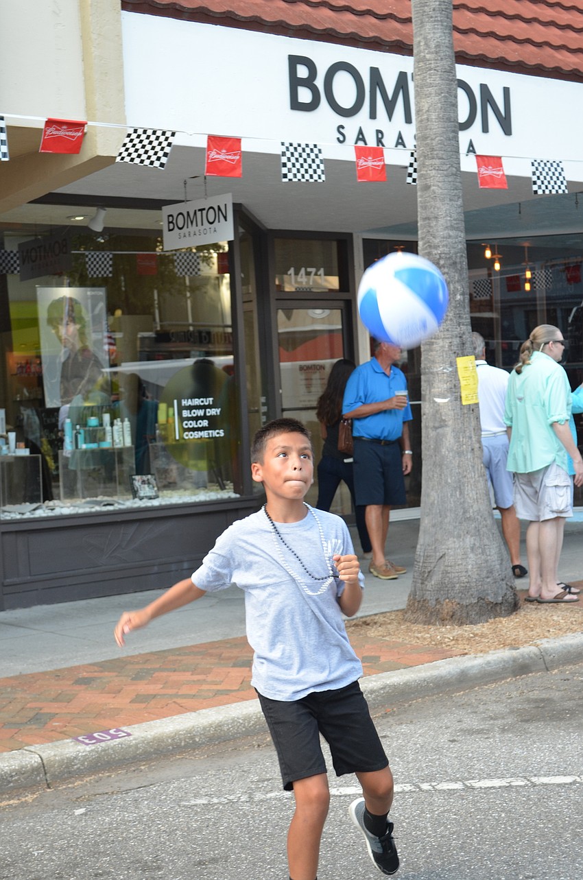 Adrian Garthaus tries out his soccer skills with a beach ball.