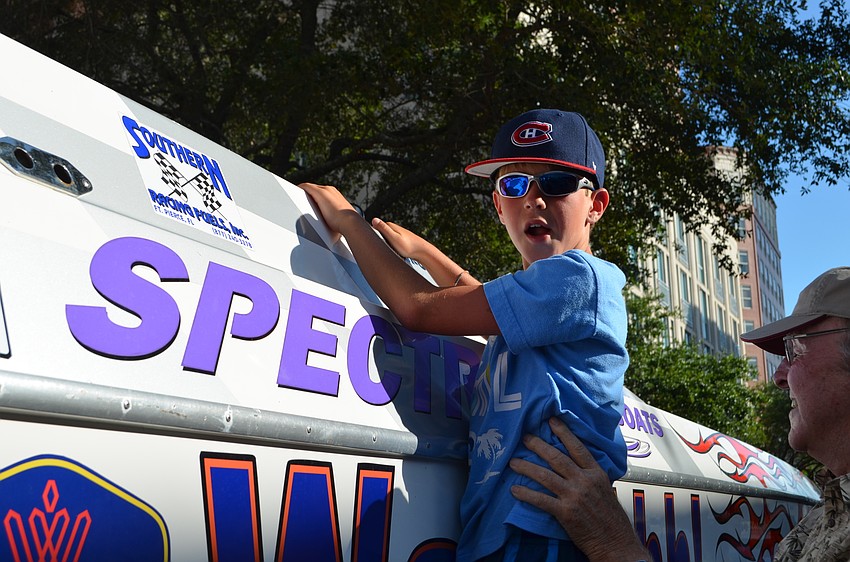 Logan Cutts gets a lift from his grandfather Peter Ross to get a closer look at Watt-Ahh!