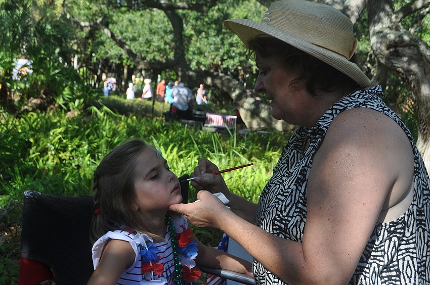 Bailey Campbell, 5, gets her face painted after the parade