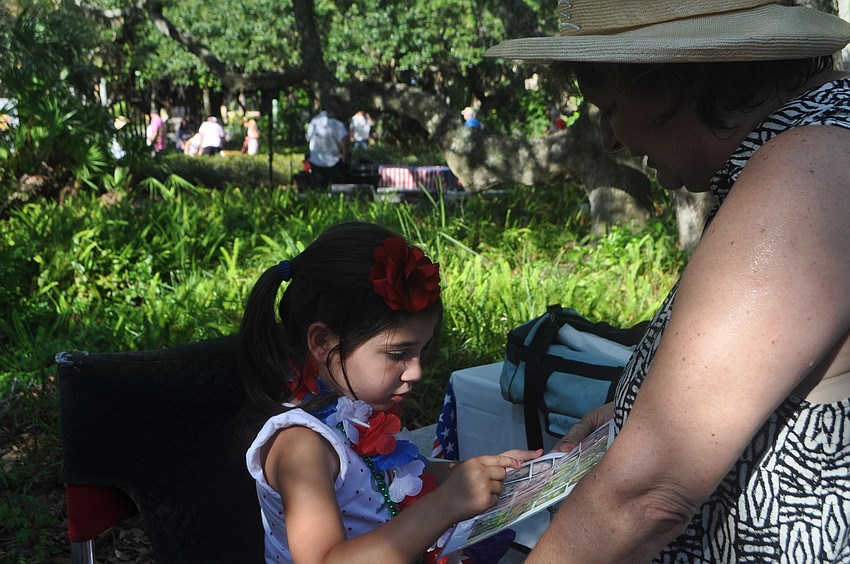 Payton Campbell, 3, chooses her face paint design
