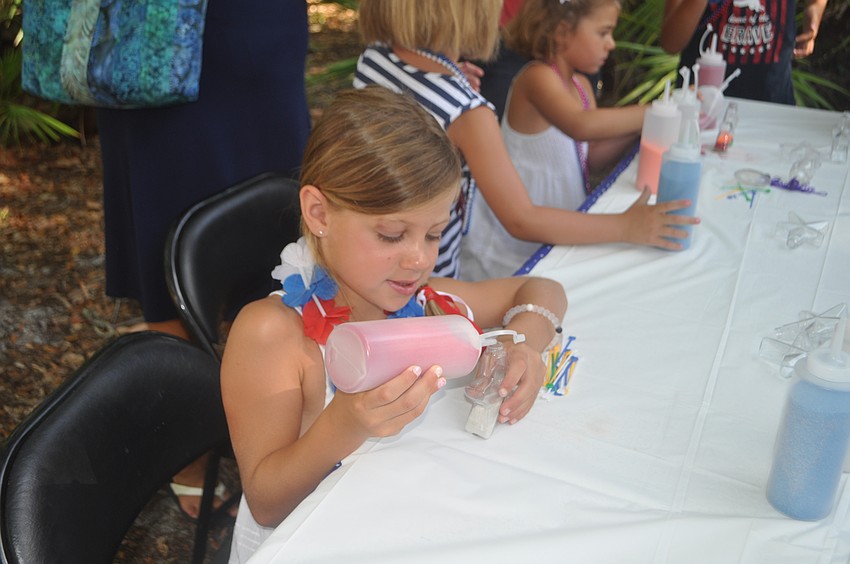 Lola Hardy, 6, makes some sand art