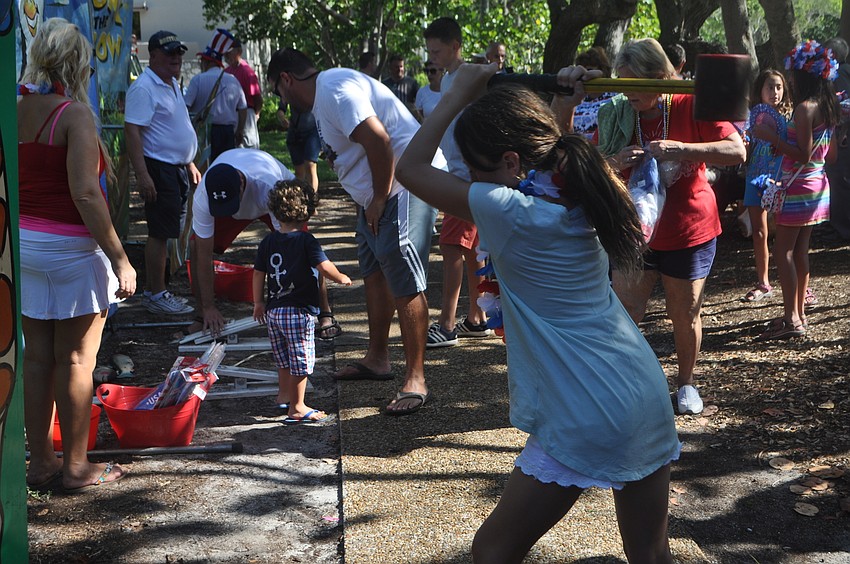 Meghan Tunney, 11, takes a swing at one of the games