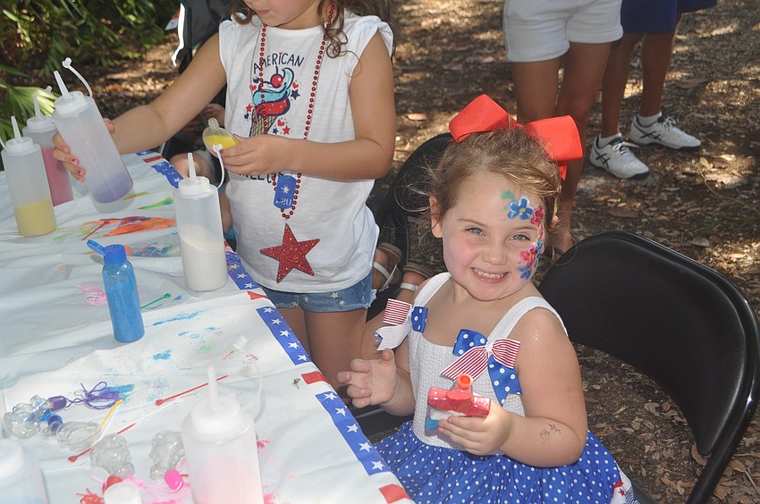 Fiona Phillips, 3, shows off her sand art