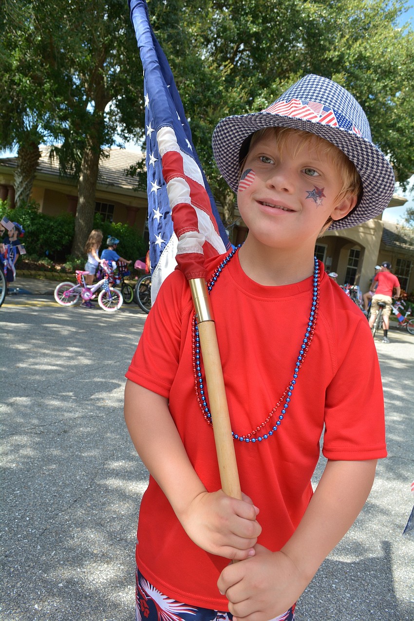 Cameron Cody, 7, led the parade with the American flag in hand.