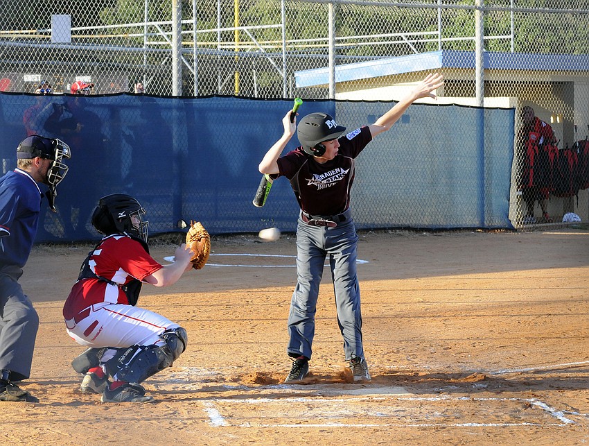 Braden River Junior All-Star James Fowler avoids getting hit by a pitch.