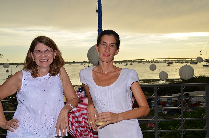 Catherine Ailes and Eliza Solomatina take in the sunset before the start of the fireworks display.