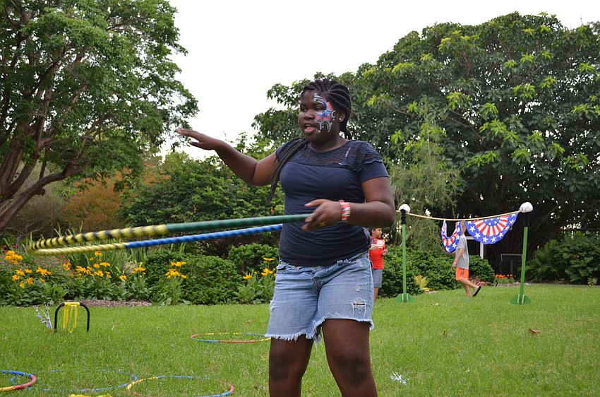 D'yera Brookins gives hula hoops a try on the great lawn at Marie Selby Botanical Gardens.