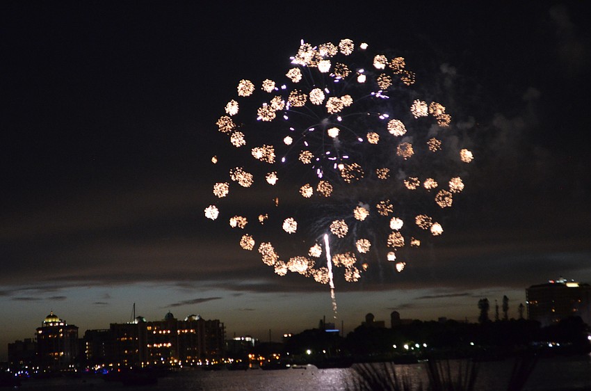 Fireworks explode in the air above Sarasota Bay to celebrate the Fourth of July.