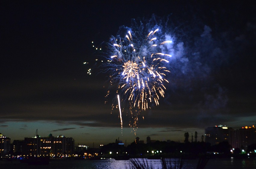 Fireworks explode in the air above Sarasota Bay to celebrate the Fourth of July.