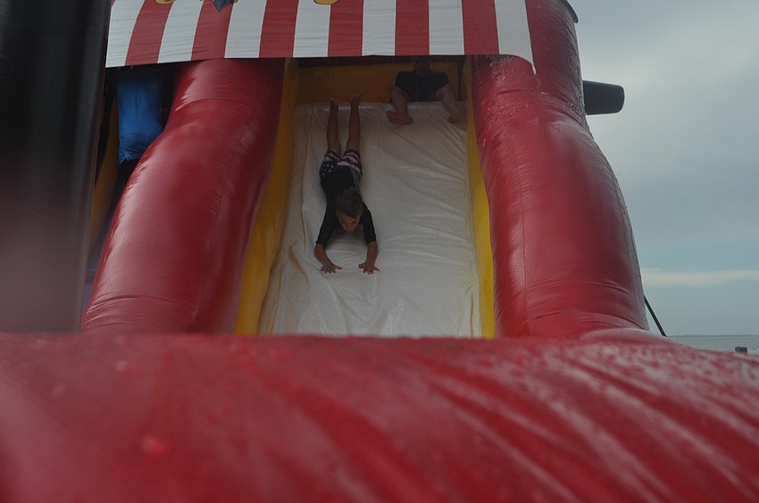 Finn Fluker,7, takes a plunge down the pirate ship-themed waterslide