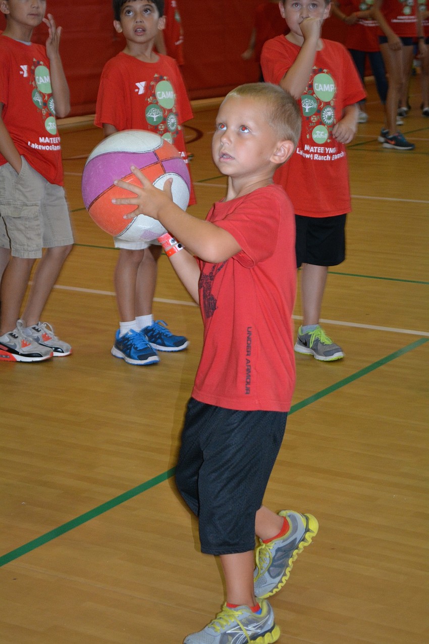 Anthony Scrimale, 6, takes a shot in the gym.
