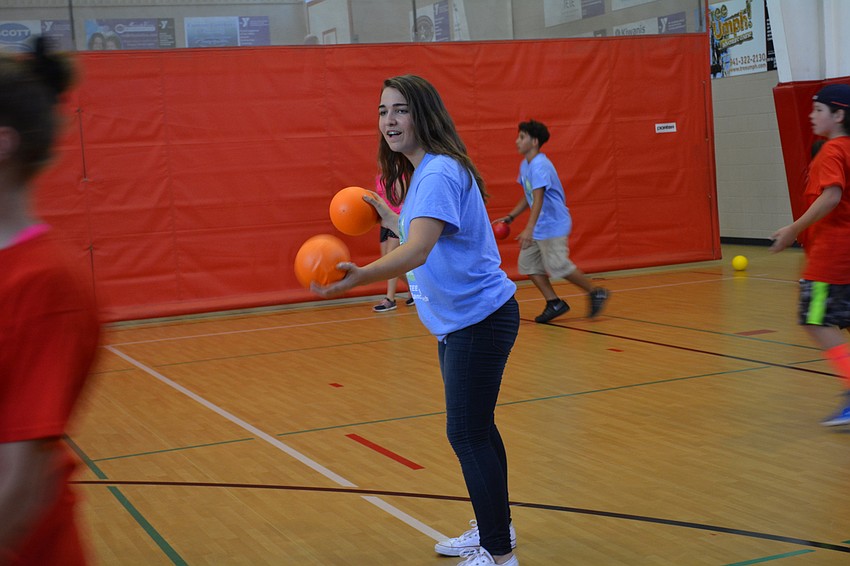 Counselor in Training Madison Wise, 14, dodges a ball thrown at her by campers.