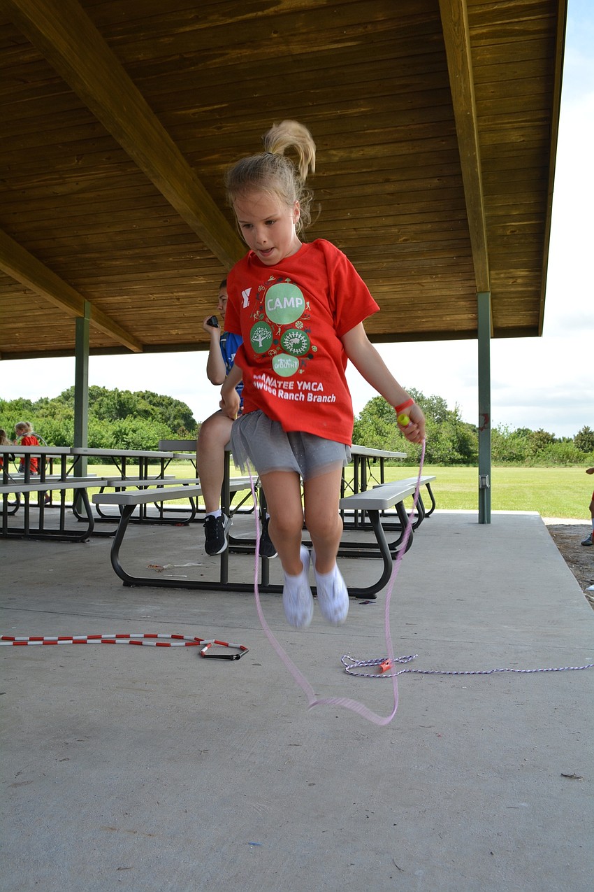 Gene Witt Elementary's Alyssa Otterness, 6, jumps rope under the shade.
