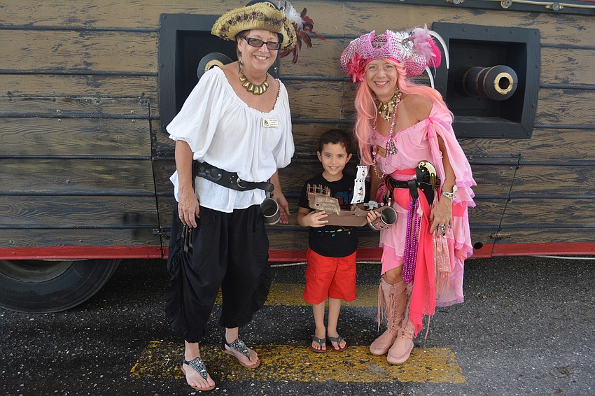 Cindy Swager and Kelly Sparkman of the Anna Maria Island Privateers surround Lakewood Ranch 5-year-old Mathew Asaad.