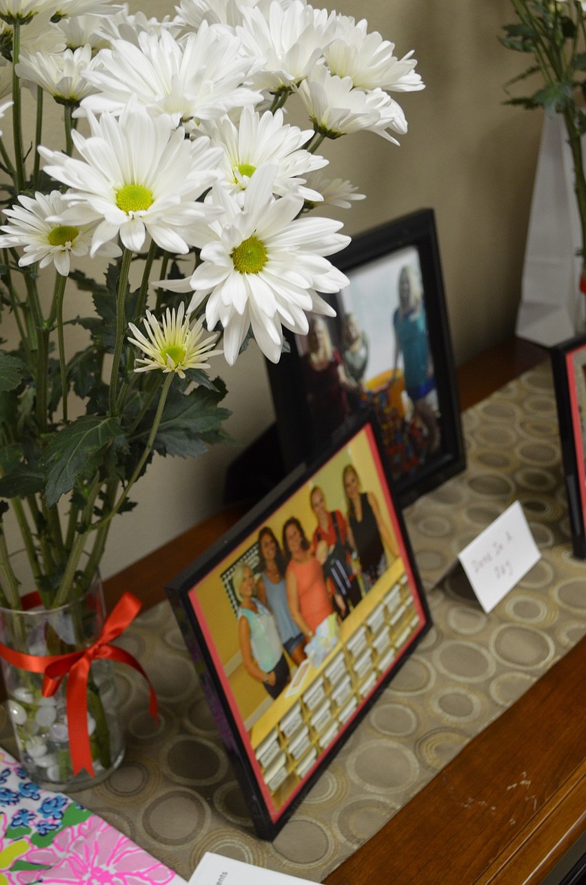 Flowers and photographs of past JLS events decorated the room.