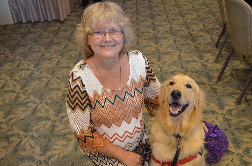 Beth Stickles and Pirate, a 2-year-old golden retriever training to be a service dog for Kids and Canines.