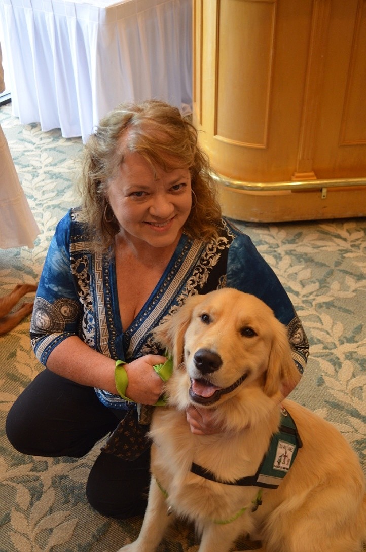 Angie Murray and Porter, a 1-year-old golden retriever training to be a service dog for Kids and Canines.