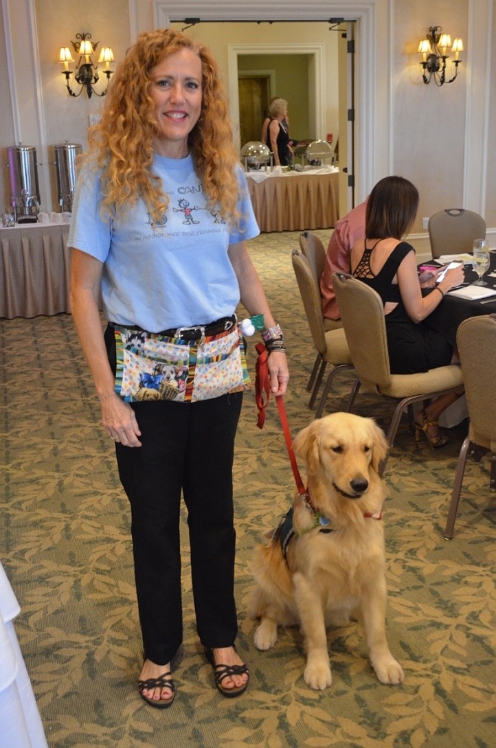 Bonnie Elozory with Patriot, a golden retriever that will become Samantha Bozza’s service dog as soon as he finishes his training.