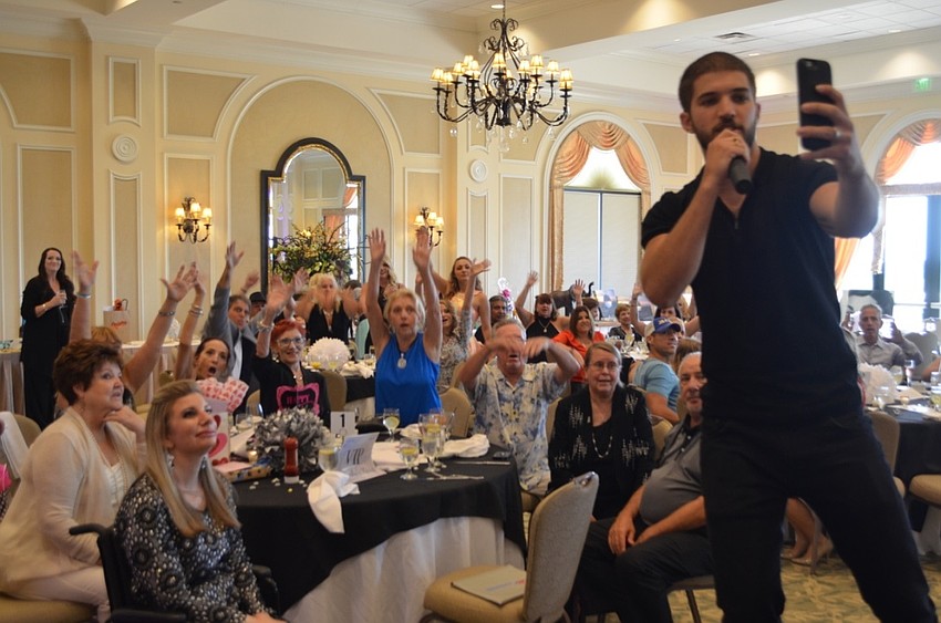 Bryan Craig telling the crowd to “do the wave” for his snapchat video.