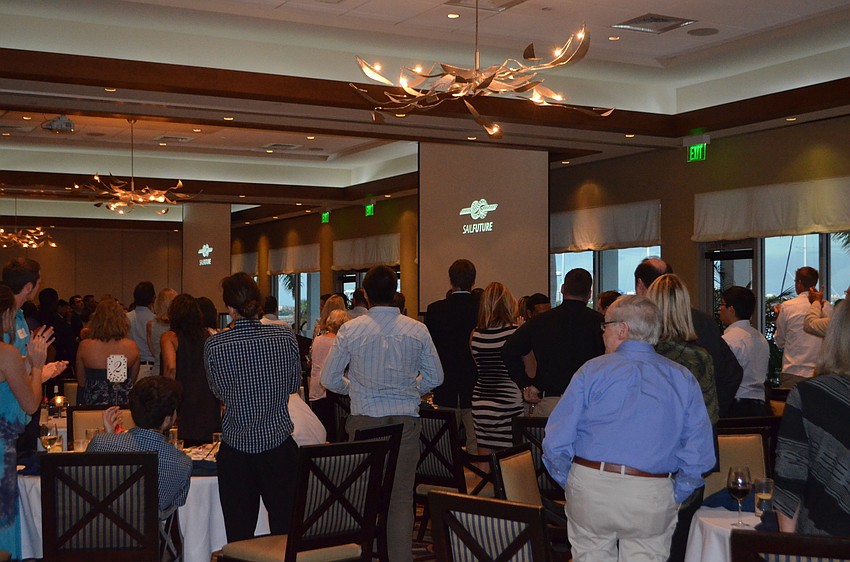 Michael Long and other guest speakers get a standing ovation following the presentation on SailFuture