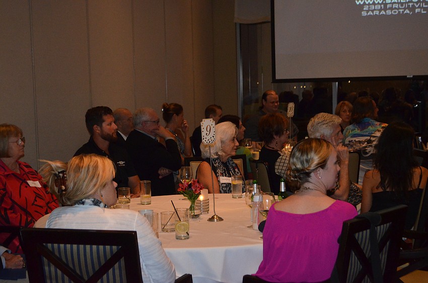 Event guests listen to Michael Long while he announces SailFuture’s next steps