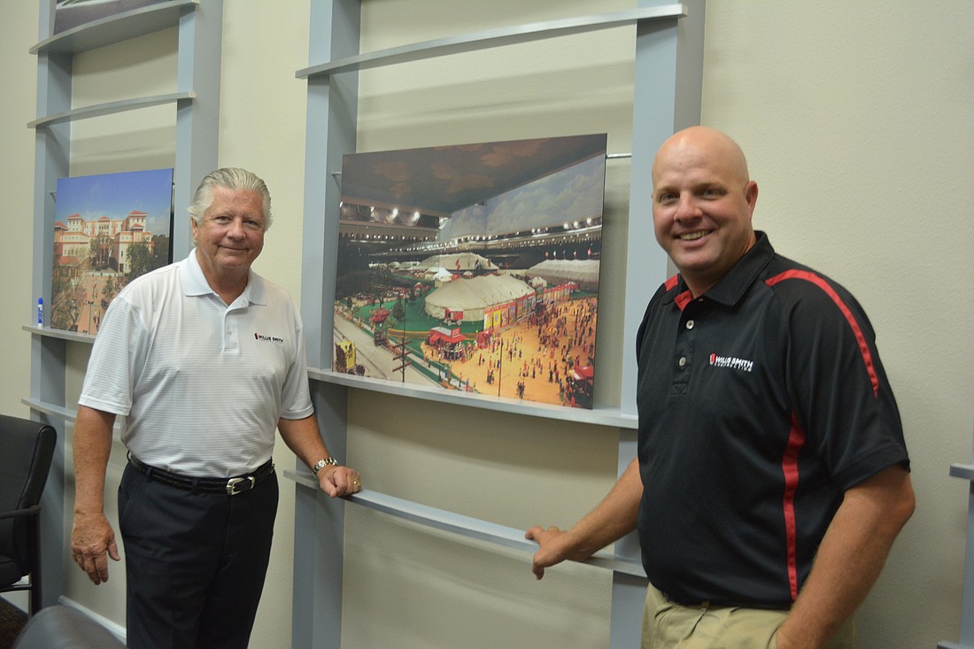 Willis Smith Vice President Kim French and Project Manager David Otterness were all smiles as they talked about their new project at the South Florida Museum. They are standing in front of a photo of a previous project at The Ringling.