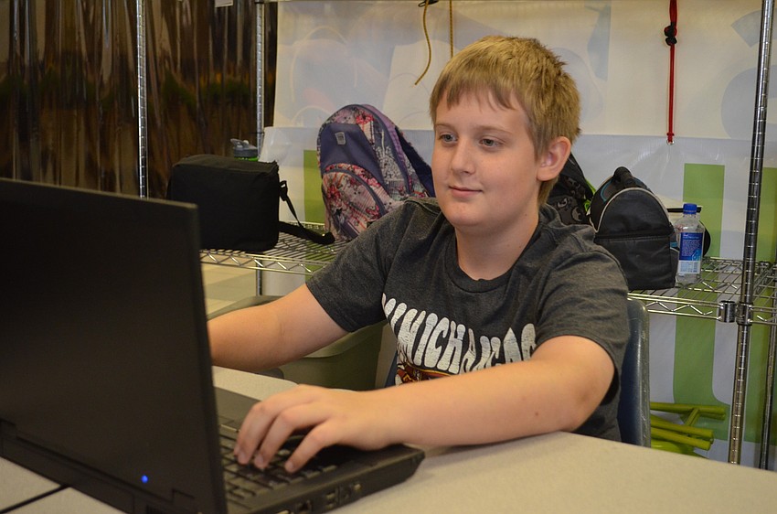 Austin Ingram works on his design using two-dimensional design software called CorelDRAW.