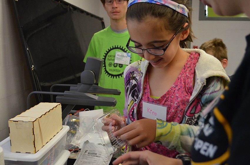 Kira Gordon pulls out part of her Play-Doh sculpture from her mold.
