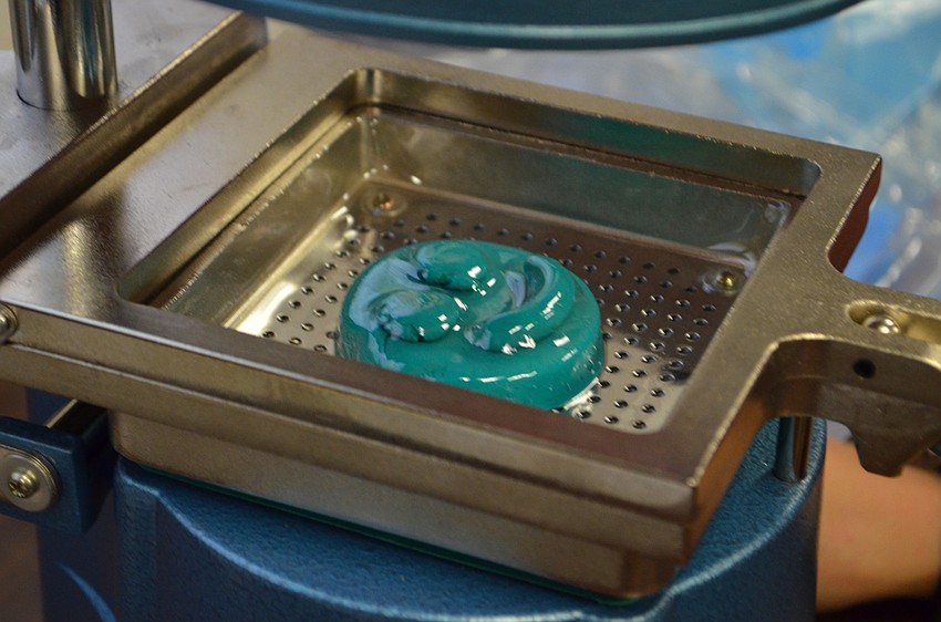 Plastic is heated and then pressed into the Play-Doh sculpture to create a reusable mold.