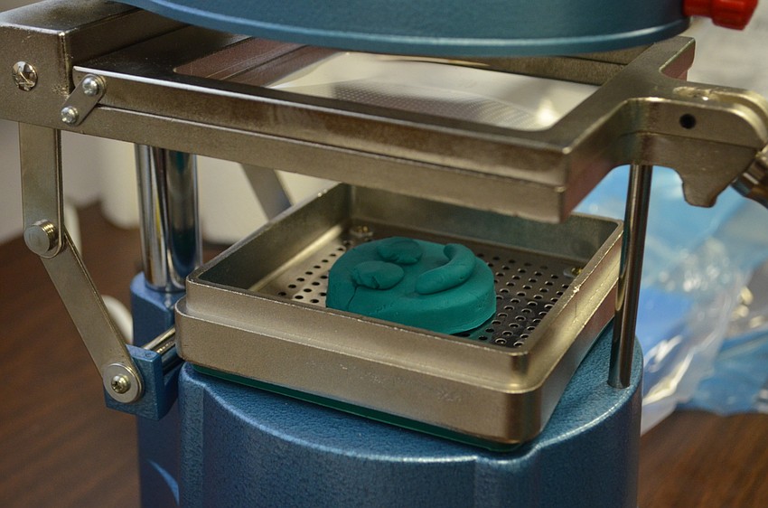 Plastic is heated and then pressed into the Play-Doh sculpture to create a reusable mold.