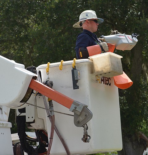 Florida Power and Light line specialist Johnny Allison has the automated lateral switch he is about to install on the 4100 block of 45th Street East in Bradenton.