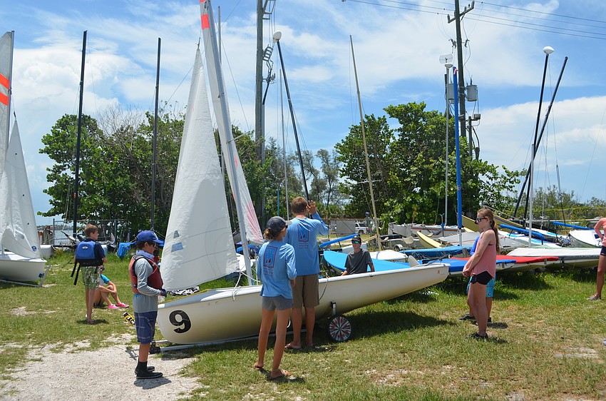 Sailing coaches instruct campers before they head out on the water.