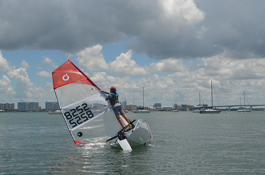 Sebastian Spinelli- Sax, 11, attempts to climb the mast of his sailboat.