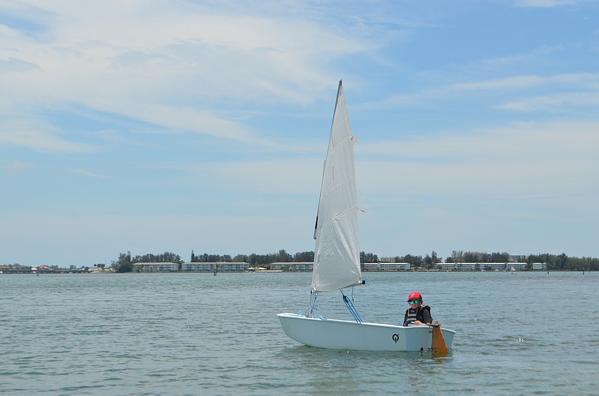 Xander Bartnesky, 8, follows fellow sailors out on the water.
