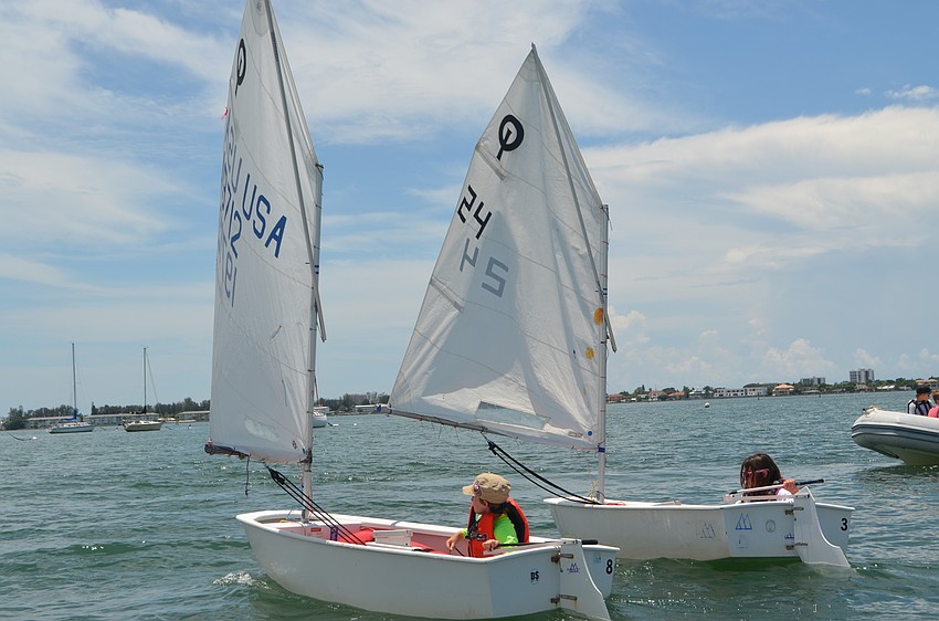 Roland Hoskins, 10, and Natalie Norman, 10, sail around the Sarasota Bay during Sarasota Youth Sailing summer camp.