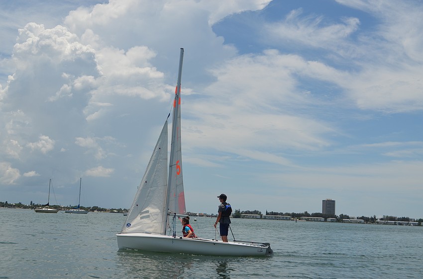 Meredith Priester, 15, and Matthew Mason, 15, work together to sail their boat around Sarasota Bay.