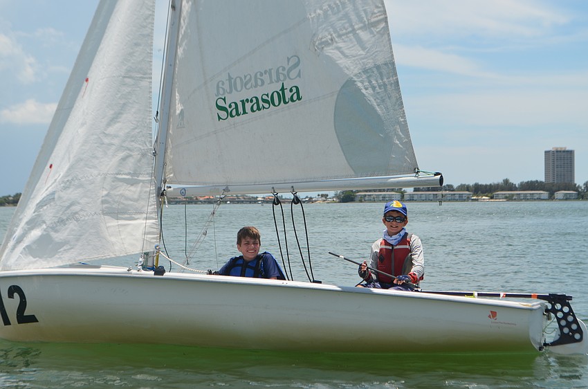 Tate Bridges, 14 and Alex Liebel, 11, sail around the bay.