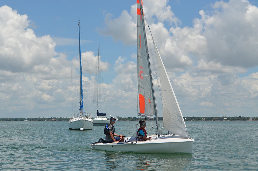 Matthew Mason, 15 and Meredith Priester, 15, sail around the bay.