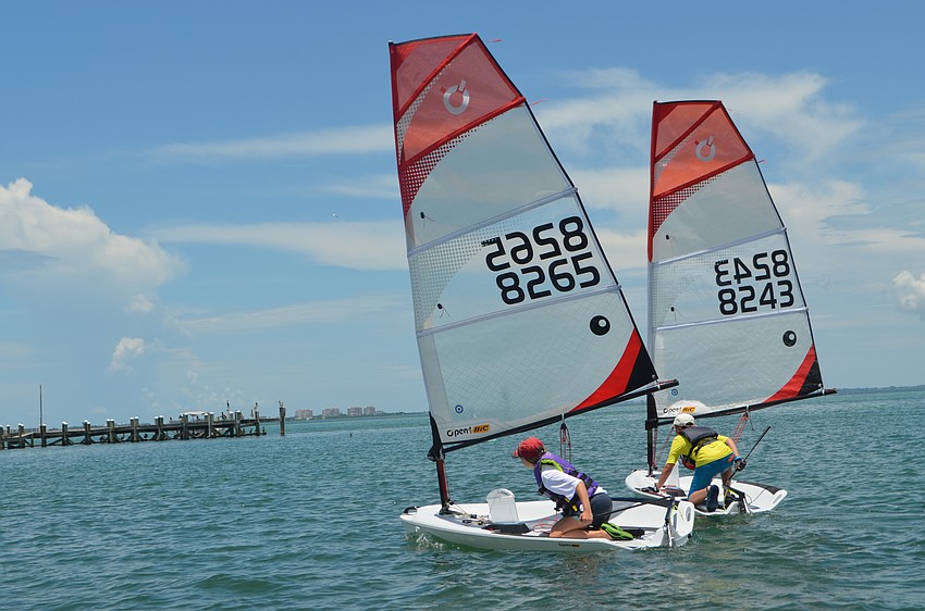 Kayla Byram, 13, and Kadin Siemer, 14, head out to sail around the bay.